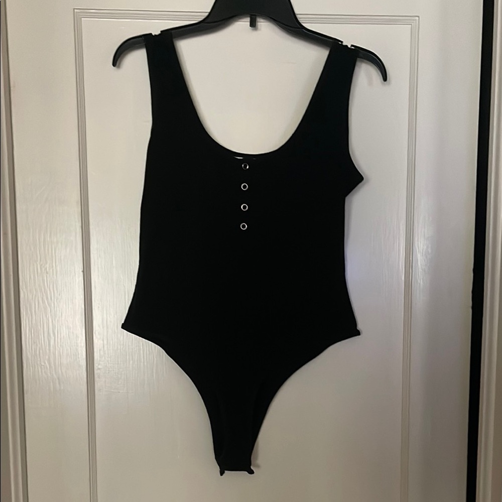 Black Bodysuit with High Neckline and Unique Silhouettes